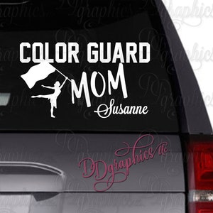 May include: White vinyl decal with the text "COLOR GUARD MOM" and a silhouette of a person holding a flag. The name "Susanne" is written in cursive below the text.