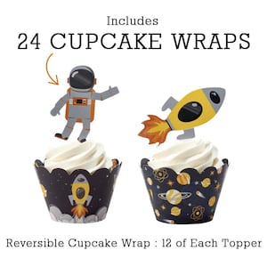 May include: Cupcake wraps with space-themed designs. The image shows two cupcakes with white frosting, each decorated with a different space-themed topper. One has an astronaut, the other a rocket. The cupcake wrappers are black with yellow and white space graphics.