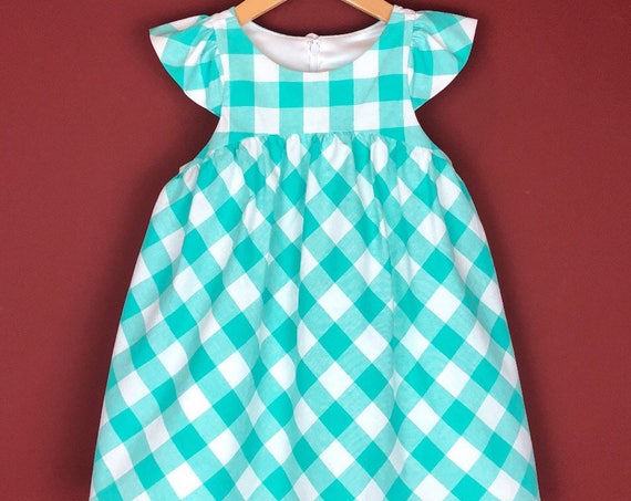 The "Flutter-By Dress" in Aqua Gingham.