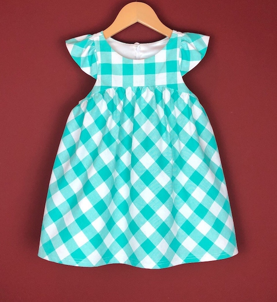 The "Flutter-By Dress" in Aqua Gingham.
