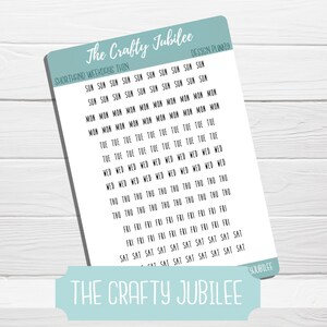 May include: A sheet of stickers with the days of the week written in shorthand. The stickers are white with black text and are arranged in rows. The text "The Crafty Jubilee" appears at the top and bottom of the sheet.