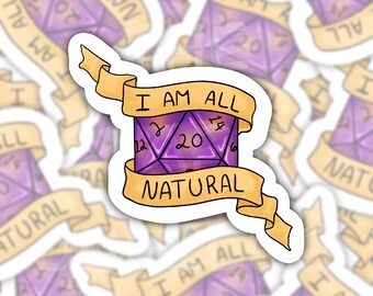 May include: A die-cut sticker featuring a purple twenty-sided die with black numbering, including a prominent 20. A tan ribbon banner wraps around the die with the black text I AM ALL NATURAL printed across the top and bottom sections of the ribbon.