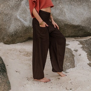 Chocolate brown high crotch harem pants with a stretchy smock waistband and one side pocket. Made from 100% rayon