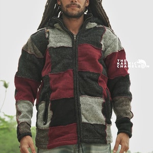 May include: A patchwork zip-up hoodie in shades of gray, black, and burgundy. The jacket features a hood, a front zipper, and a drawstring at the hem. The Karmic Chameleon logo is visible on the right side.