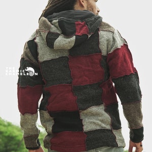 May include: A patchwork hoodie in shades of gray, black, and burgundy. The hoodie features a hood and is worn with light blue jeans. The Karmic Chameleon logo is visible on the left side of the hoodie.