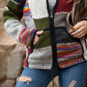 May include: A multi-colored patchwork knitted jacket with a zipper closure. The jacket has a variety of colors including green, red, blue, and grey. The jacket has a pocket on the left side.