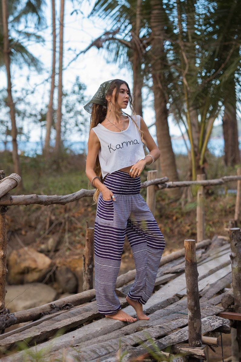 purple and white horizontal striped loose trousers with elasticated, tapered ankles and smock waistband