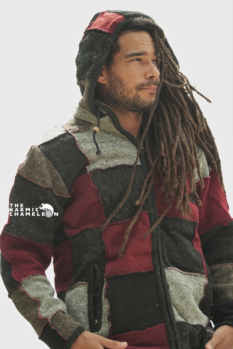 May include: A patchwork hooded jacket in shades of gray, black, and burgundy. The jacket features a zipper closure, a drawstring hood, and a small pocket. The Karmic Chameleon logo is visible on the left side.