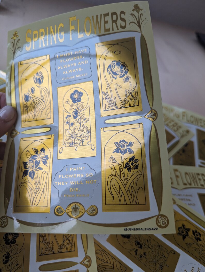 May include: A set of gold foil stickers featuring illustrations of spring flowers and quotes about flowers. The quotes are by Claude Monet and Frida Kahlo. The stickers are on a white background with a gold border. The text on the stickers reads: "I must have flowers, always and always." - Claude Monet and "I paint flowers so they will not die." - Frida Kahlo.
