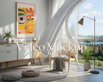 May include: A modern living room scene with a large framed abstract art piece in orange, yellow, and pink tones. A white and wood-toned cabinet, a chair, and a floor lamp are also visible. The text "Video Mockup" is displayed.