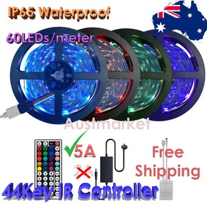 May include: Three spools of LED light strips with a 44-key IR remote control, a power adapter, and a 5A power supply. The light strips are blue, red, and green. The text "IP65 Waterproof" and "60 LEDs/meter" is visible on the image.