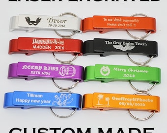 May include: A selection of laser-engraved bottle openers in colours such as silver, orange, red, black, purple, green, blue, and gold. Each opener has custom text and dates, with a keyring attached.