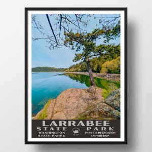 May include: A vintage-style poster for Larrabee State Park in Washington. The poster features a scenic view of a lake with a tree on a rocky shore. The text on the poster reads "Larrabee State Park, Washington State Parks, Parks & Recreation Commission."