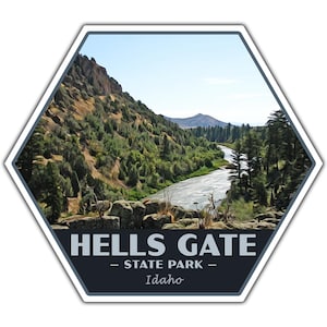 May include: Hexagon-shaped sticker featuring a scenic view of Hells Gate State Park in Idaho. The image shows a river winding through a canyon with lush green trees and a clear blue sky. The text "HELLS GATE - STATE PARK - Idaho" is displayed at the bottom.