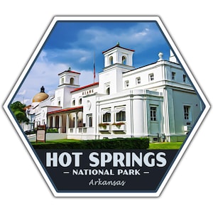 May include: A hexagonal sticker with a white building with a red roof and the text "HOT SPRINGS - NATIONAL PARK - Arkansas". The building is surrounded by green trees and a blue sky with white clouds.