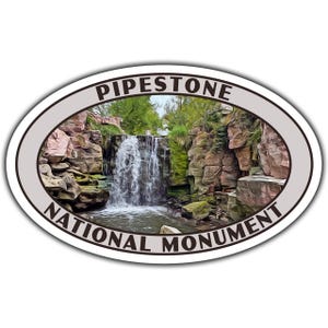 May include: Oval sticker featuring a scenic view of Pipestone National Monument. The image showcases a waterfall cascading over layered rock formations, surrounded by lush greenery. The text "Pipestone National Monument" is arched above and below the image.