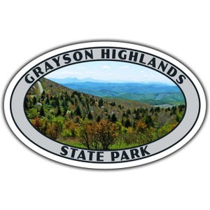May include: Oval sticker featuring a scenic view of Grayson Highlands State Park. The image shows a mountain landscape with a winding road, lush green trees, and blue layered mountains in the background. The text "GRAYSON HIGHLANDS STATE PARK" is printed around the border.