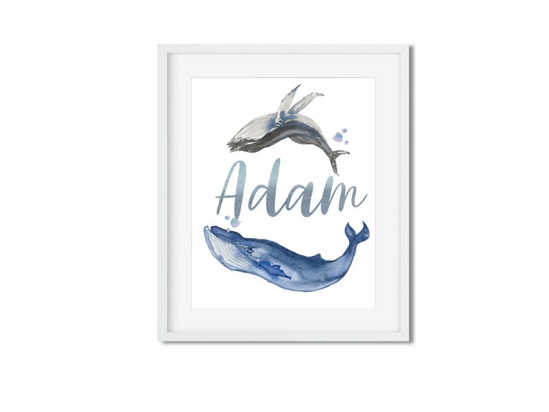 May include: A watercolor print featuring two blue whales, one jumping and one swimming, with the name "Adam" written in a silver script font.
