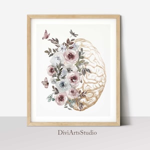 K&ouml;nnte beinhalten: Ein Aquarellbild eines menschlichen Gehirns mit einem Blumenarrangement aus rosa, wei&szlig;en und blauen Blumen. Das Gehirn ist in Gold umrandet und die Blumen sind um das Gehirn herum angeordnet. Das Bild ist in einem hellen Holzrahmen gerahmt. Der Text "DiviArtsStudio" befindet sich am unteren Rand des Bildes.