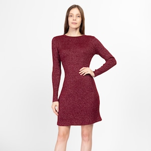 May include: A burgundy ribbed knit dress with a round neckline and long sleeves.