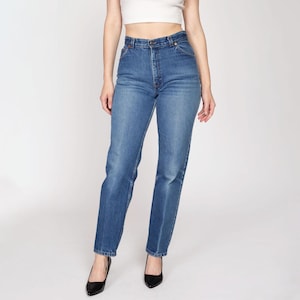 May include: A pair of high-waisted, straight-leg blue jeans. The jeans have a classic fit and a light wash.