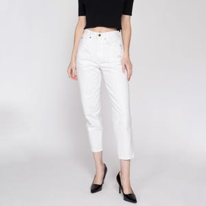 May include: White high-waisted cropped jeans with a straight leg fit.
