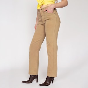May include: A pair of light brown, straight-leg jeans with a high waist.