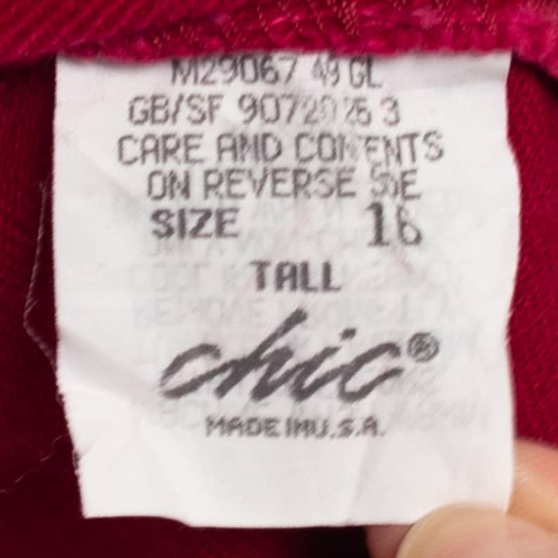 May include: White tag with black text that reads "M29067 49 GL", "GB/SF 90720 25 3", "CARE AND CONTENTS ON REVERSE SIDE", "SIZE 16 TALL", "chic&reg;", and "MADE IN U.S.A."