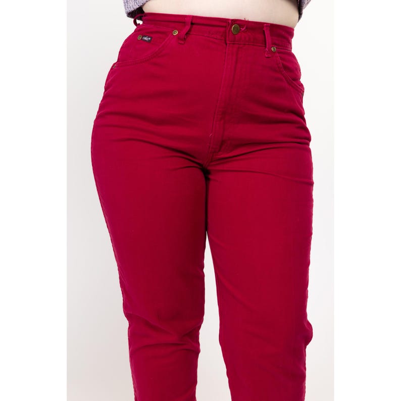 May include: High-waisted red jeans with a straight leg fit.
