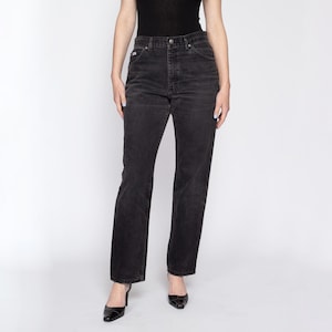 May include: Black high-waisted straight leg jeans with a classic fit.