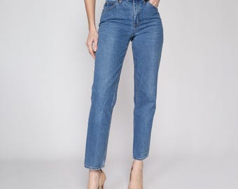 May include: A pair of blue denim jeans with a straight leg fit. The jeans have a high waist and a classic five-pocket style.