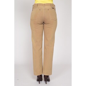 May include: A pair of tan straight-leg jeans with a high waist and a classic fit.