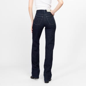 May include: A pair of dark blue high-waisted jeans with a straight leg fit.