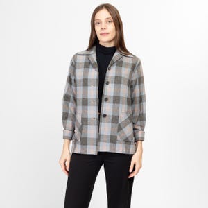 May include: A gray and blue plaid shirt jacket with a collared neckline and button closure. The jacket has two patch pockets on the front and a long sleeve.