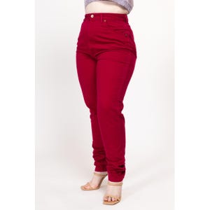 May include: A pair of high-waisted, red jeans. The jeans are a slim fit and have a straight leg.