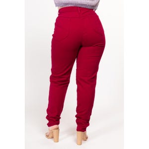 May include: A pair of high-waisted, red, straight-leg jeans.