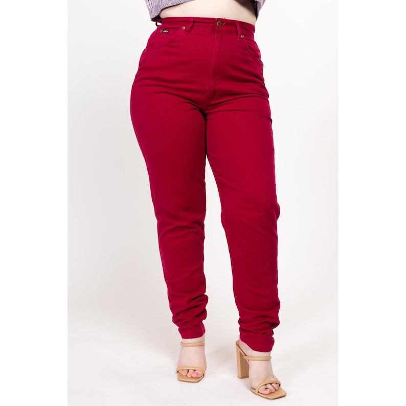 May include: High-waisted, red denim jeans with a straight leg fit.