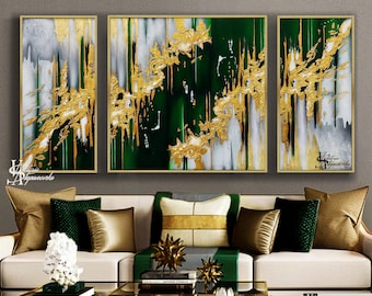 May include: Three abstract paintings in gold and green tones. The paintings are framed in gold and feature a modern abstract design with splashes of gold paint.