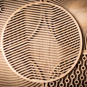 May include: Three circular wooden wall decorations with different geometric patterns. The patterns are made of thin strips of wood that are cut and arranged to create a unique design. The pieces are all in shades of brown.