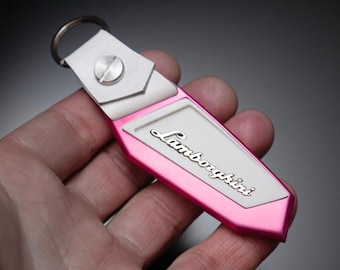 Pink Lamborghini keychain, Anodized aluminum, carbon fiber, bronze lettering, Leather, Urus, Aventador, Huracan, murcielago, Gallardo