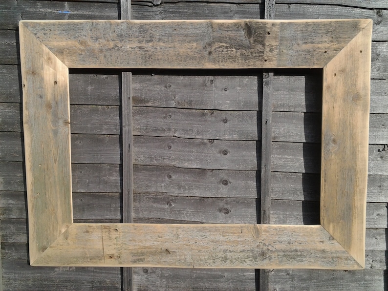 May include: A rustic wooden picture frame with a natural wood finish. The frame is made of reclaimed wood and has a distressed look.