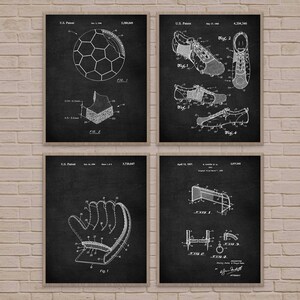 May include: Set of four black and white vintage patent prints featuring illustrations of a soccer ball, soccer cleats, a soccer glove, and a soccer goal. The prints are framed with a white border.
