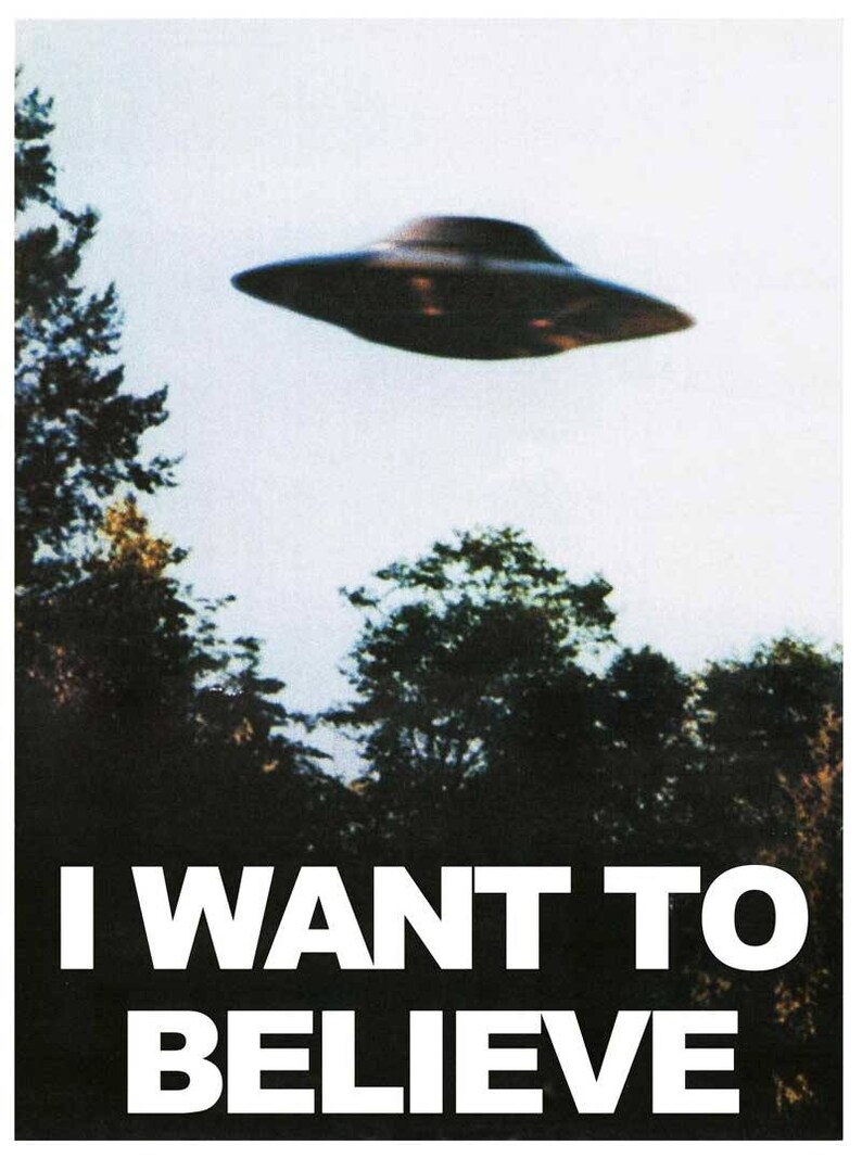 May include: A black and white poster with a flying saucer in the sky and the text "I WANT TO BELIEVE" at the bottom.