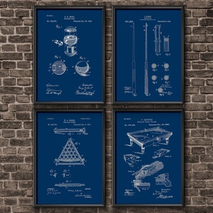 May include: A set of four vintage blueprint style prints featuring historical patents for billiard equipment. The prints are framed in black and feature a blue background with white illustrations and text. The prints include patents for a billiard ball, a billiard cue, a billiard table, and a billiard ball rack.