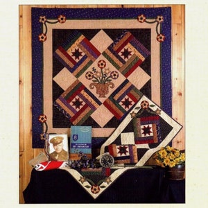 May include: A printed pattern for a quilt and runner, titled "Freedom Blooms." The design features a central floral motif and star accents. The image includes a finished quilt and runner, along with other decorative items.
