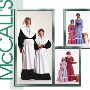 May include: McCall's sewing pattern envelope featuring illustrations of historical-style costumes. Designs include black dresses with white aprons and bonnets, blue and red gingham dresses with bonnets, and floral print dresses with matching bonnets.