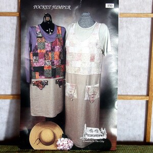 May include: A poster featuring two dresses on mannequins. The dress on the left has a patchwork design with various colors, while the one on the right is white with a beige bottom. A straw hat and flowers are at the bottom.