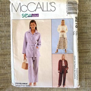 May include: A McCall's sewing pattern package featuring three different outfits. The package includes a lavender pantsuit, a cream-colored jacket and floral skirt, and a burgundy pantsuit. The package has the text "McCALL'S" and "sewnews".