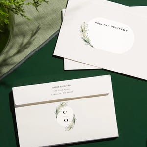 May include: White envelope with a green floral design and the text "Chloe & Oliver" and "100 Cook Street,  Cresson, TN 40009". The envelope also has a round sticker with the initials "C O" in a circle with a green floral design.