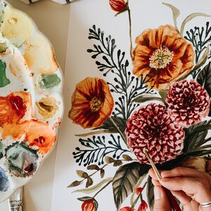 May include: A watercolour painting of a floral bouquet featuring red, orange, and green flowers. The painting is on a white background and is being painted by a person using a paintbrush.